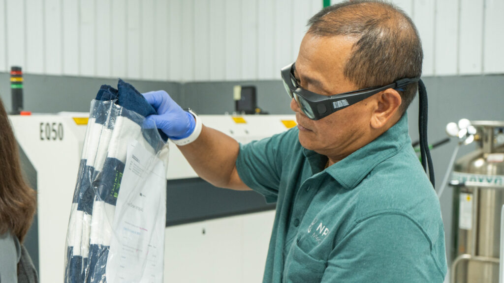 A bio medical engineer at NPX Medical organizes equipment during the medical device prototype development process.