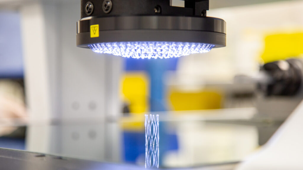 An LED light hovers above a medical device prototype